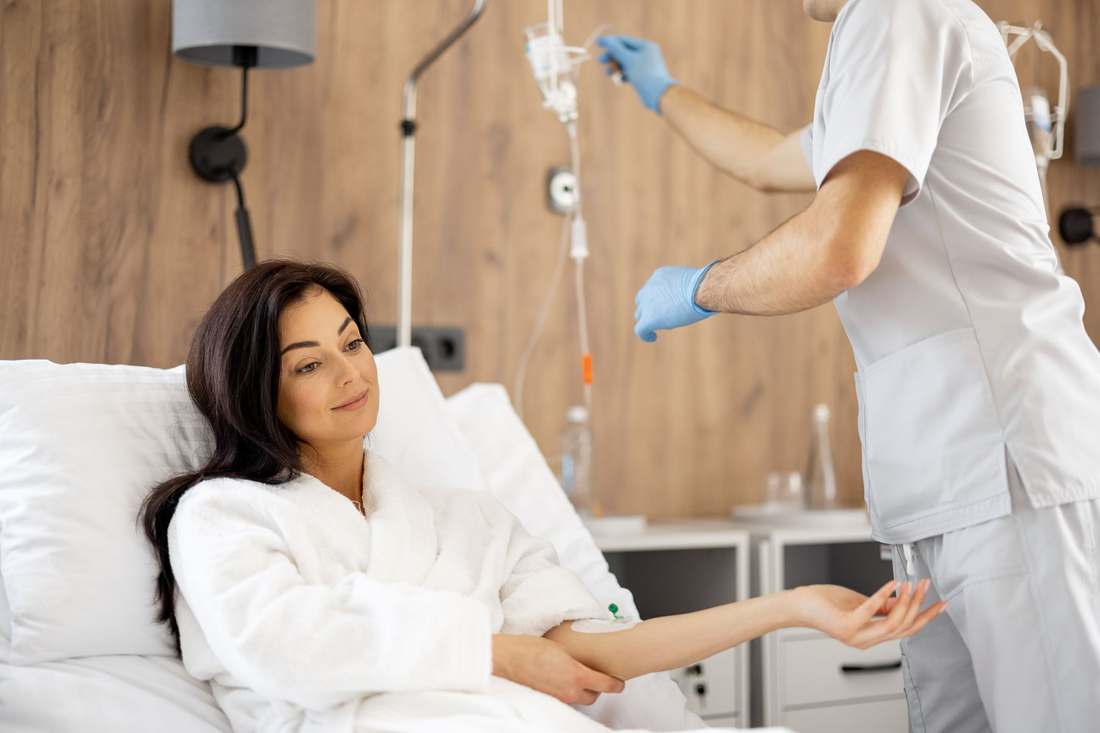 Provider preparing IV hydration for a patient at Aura Health & Wellness